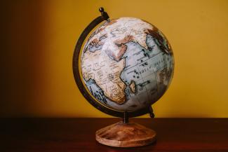 Picture of a globe against a yellow background